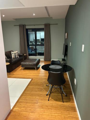 a living room with a table and a couch at Lofty-Space in Gaborone