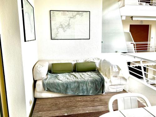 - un salon avec un canapé et des oreillers verts dans l'établissement Perle Rare Cannes Croisette Vue Mer Parking 4P, à Cannes