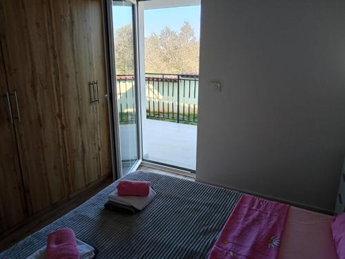 a bedroom with a bed and a large glass door at Apolo Apartments in Pula