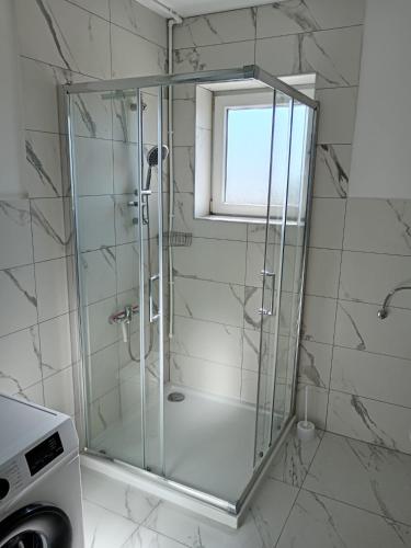 a shower with a glass door in a bathroom at Apolo Apartments in Pula