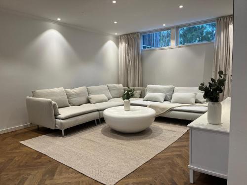 a living room with a couch and a coffee table at The Scandic Luxe- Stockholm Arlanda in Stockholm