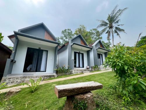 a row of cottages with a bench in the yard at Makarma Resort Lombok in Senggigi 