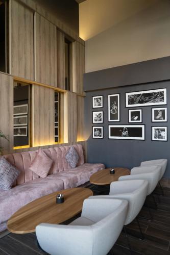 a living room with a pink couch and tables at The View Agadir in Agadir