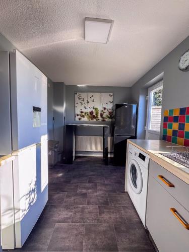 a kitchen with a washer and dryer in a room at Newly Refurbished Home fit for to 7 family members, Groups, Contractors Centre of Bradley Stoke in Bristol