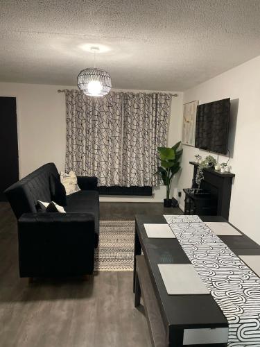 a living room with a couch and a table at Newly Refurbished Home fit for to 7 family members, Groups, Contractors Centre of Bradley Stoke in Bristol