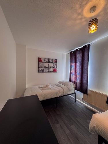a room with two beds and a window at Newly Refurbished Home fit for to 7 family members, Groups, Contractors Centre of Bradley Stoke in Bristol