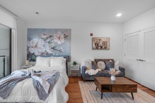 a bedroom with a bed and a couch at Skyline Studio - Modern Comfort Pool Access in Philadelphia