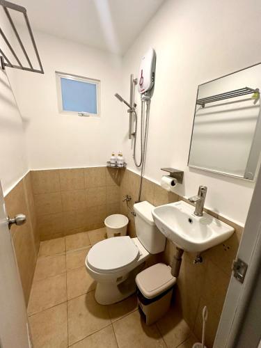 a bathroom with a toilet and a sink at Cozy 2BR Staycation Deca Talomo near Toril & Puan in Davao City