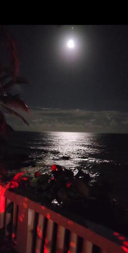 a full moon over the ocean at night at Sunrise in Villas del Faro in Emajagua