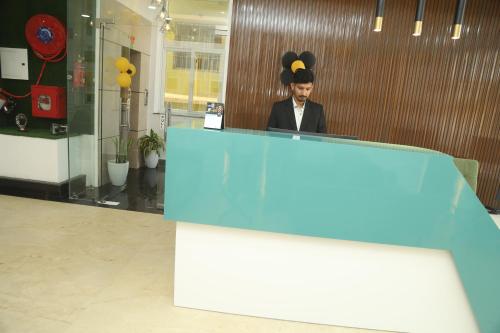 a man sitting at a desk in an office at Geetanjali International Annex a unit of Geetanjali International in Deoghar