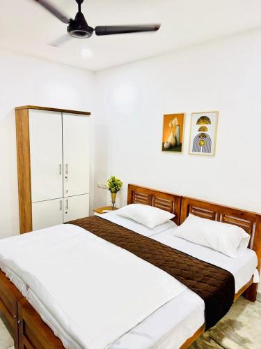 two beds sitting next to each other in a bedroom at Rahima Villa Ground floor in Cochin