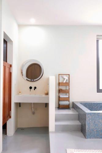 a bathroom with a sink and a mirror at Panacea The Villa in Mộc Châu