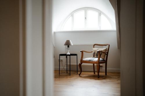 a chair and a table in a room with a window at Gut Zahren in Gallin