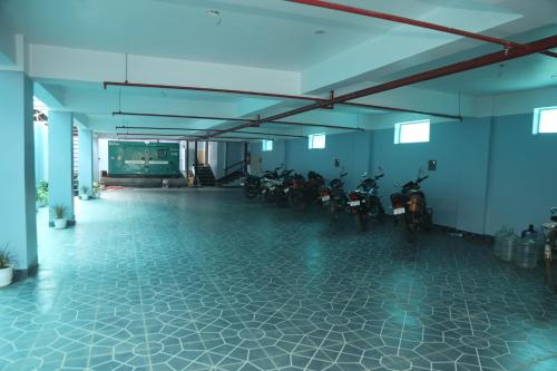 a group of motorcycles parked in a large room at Geetanjali International Annex a unit of Geetanjali International in Deoghar