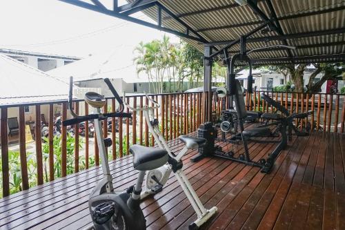 a gym with a exercise bike and a treadmill at Kos 168 Jimbaran in Jimbaran