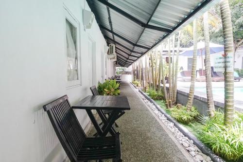 a patio with a table and a bench on a building at Kos 168 Jimbaran in Jimbaran