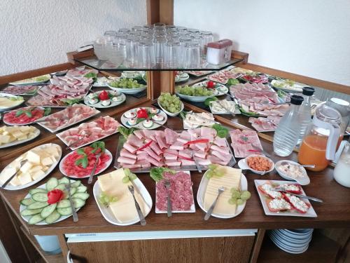 a table filled with different types of food at Hotel-Pension Friesenruh in Bensersiel