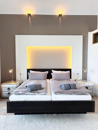 a bedroom with a large bed with two pillows at Penthouse Kapitänsbrücke in Kappeln