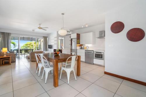 a kitchen and dining room with a table and chairs at Kanope Bay - Holiday Beachfront Apartments in Pointe aux Biches