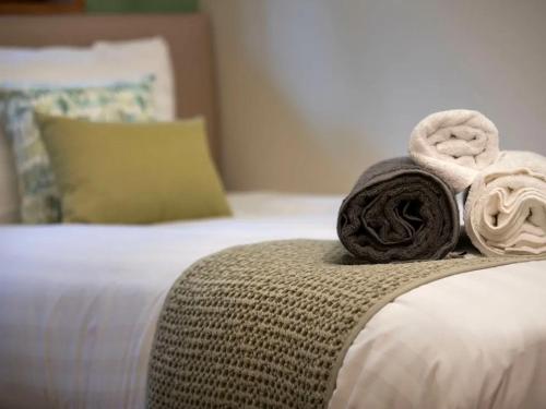 a pile of towels sitting on top of a bed at Strathyre, Ben Ledi Cabins - Forest Holidays in Callander