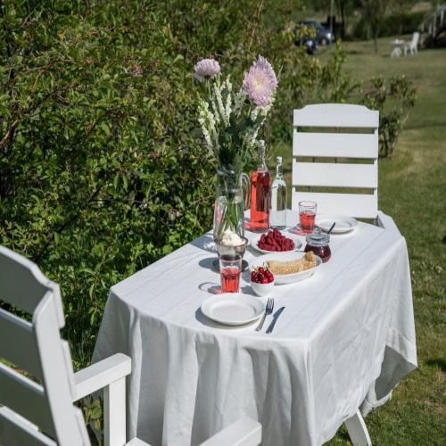 a white table with a white table cloth on it at Solstickan Hotell & Vandrarhem in Mellbystrand