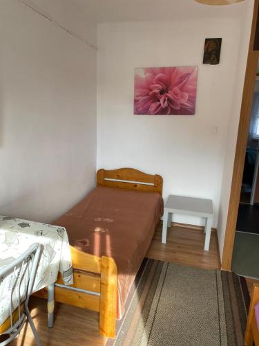a small bedroom with a bed and a table at Pokoje przy Tamie in Włocławek