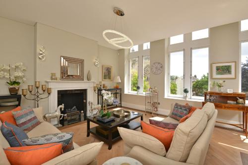 a living room with two couches and a fireplace at Apartment 1 24 Cathedral Yard Cathedral View in Exeter