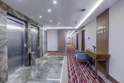 a corridor of a corridor of an office with a desk at Nearport Hotel Sabiha Gokcen Airport in Istanbul
