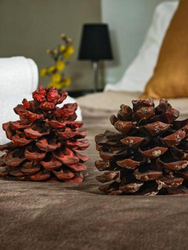 two pine cones are sitting on a bed at Ament's B&B in Siracusa