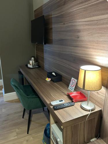 a desk in a room with a lamp and a chair at 7th Floor Suite in Naples