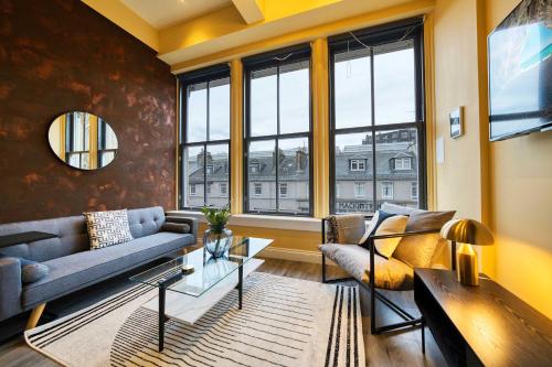 a living room with a couch and a table at Union Court Mezzanine - B9 - Building has no lift and stairs to all apartments in Glasgow