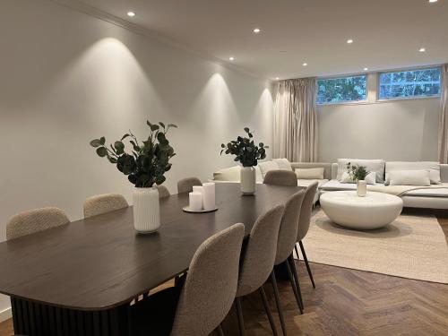 a dining room with a table and chairs and a couch at The Scandic Luxe- Stockholm Arlanda in Stockholm
