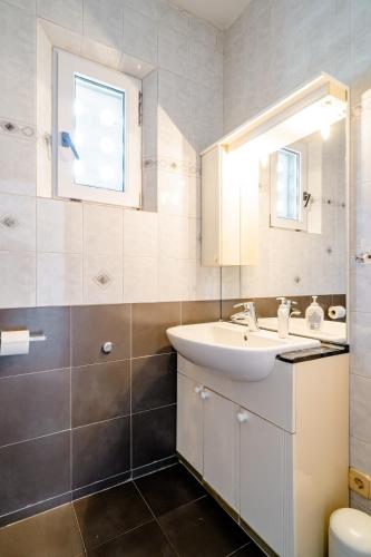 a bathroom with a sink and a mirror at Rooms Keti - Yellow room in Korčula