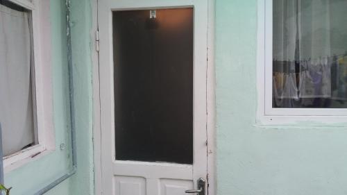 an open door with a window in a house at Guest House Nise in Tbilisi City