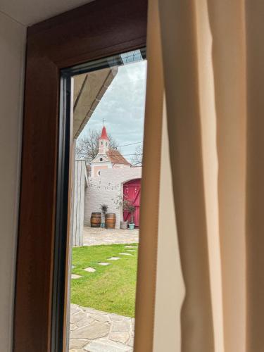 a view of a church through a window at Penzion U Kapličky in Znojmo