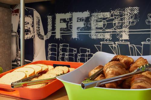 a table with a box of bread and pastries at Hotel Ibis Budget Nancy Centre in Nancy