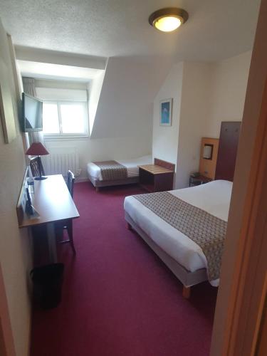 a hotel room with a bed and a desk at Logis De La Loire - Restaurant Les Bateliers in Ancenis