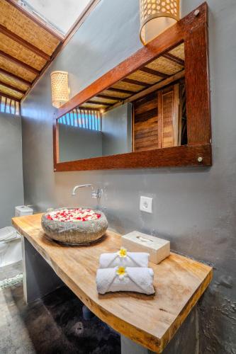 a wooden table with a cake on top of it at Lumbung Bukit Resort Uluwatu in Uluwatu