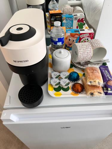 a coffee maker sitting on top of a refrigerator at STARS LUXURY HOME in London