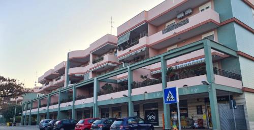 a large building with cars parked in front of it at The Cozy Place in Bari Palese