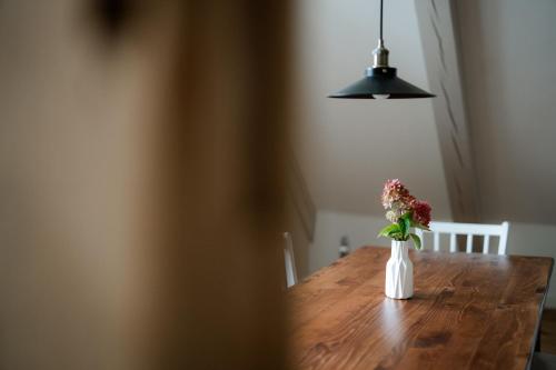 a vase of flowers sitting on a wooden table at Gut Zahren in Gallin