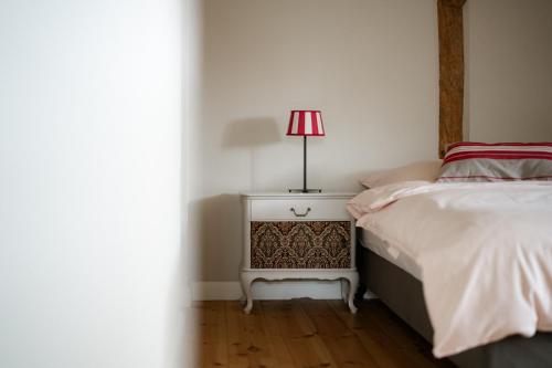 a bedroom with a bed and a lamp on a night stand at Gut Zahren in Gallin