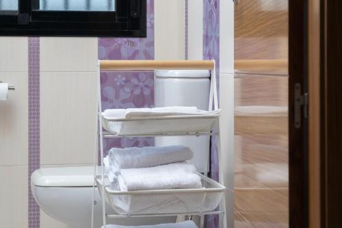 a bathroom with a towel rack next to a toilet at Chalet - Montes de Oca in El Puerto de Santa María