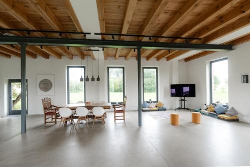 a living room with a dining room table and chairs at Gut Zahren in Gallin