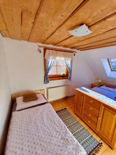 A bed or beds in a room at Zrub Liptovec