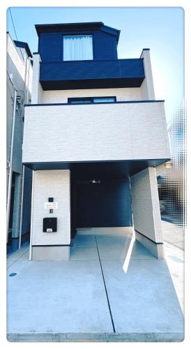 a building with a parking lot with a garage at Hao Bros Home Gemini B in Tokyo