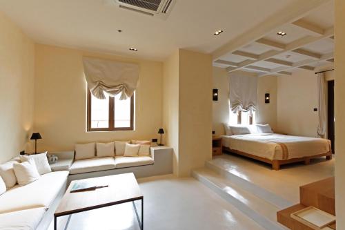 a bedroom with a bed and a couch at Toscana Town Square Suites in Mu Si