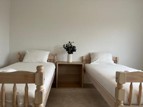 two beds sitting next to each other in a bedroom at The Scandic Luxe- Stockholm Arlanda in Stockholm