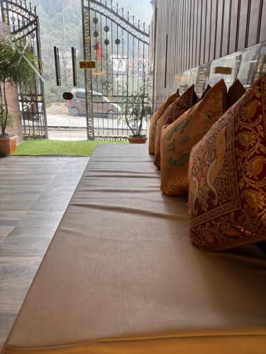 a row of pillows sitting on top of a bed at Hills Royal Residency in Jālāpahār