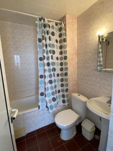a bathroom with a toilet and a sink and a shower at Hotel Noy in Varna City